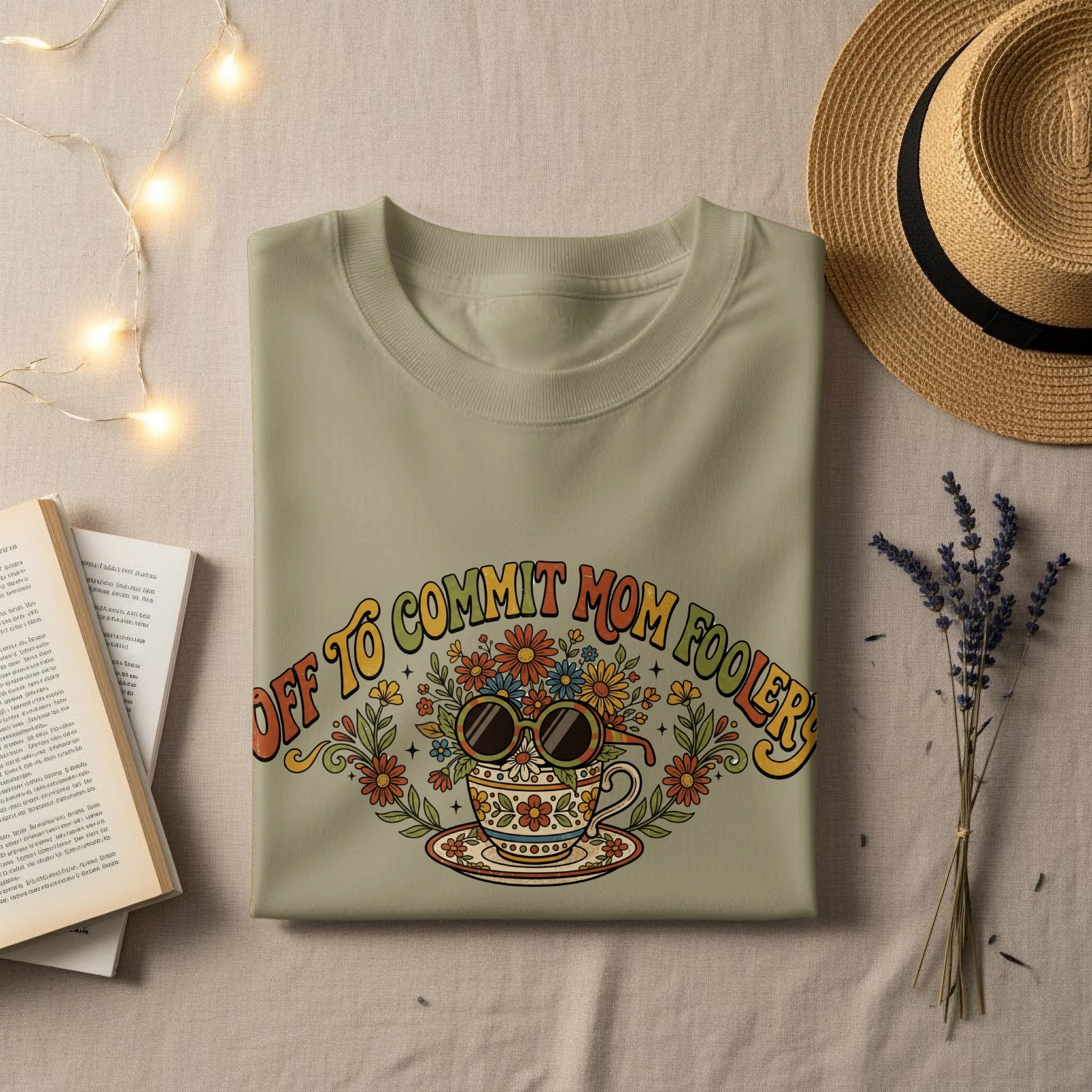 T-shirt with "Off to Commit Mom Foolery" text and floral teacup graphic.