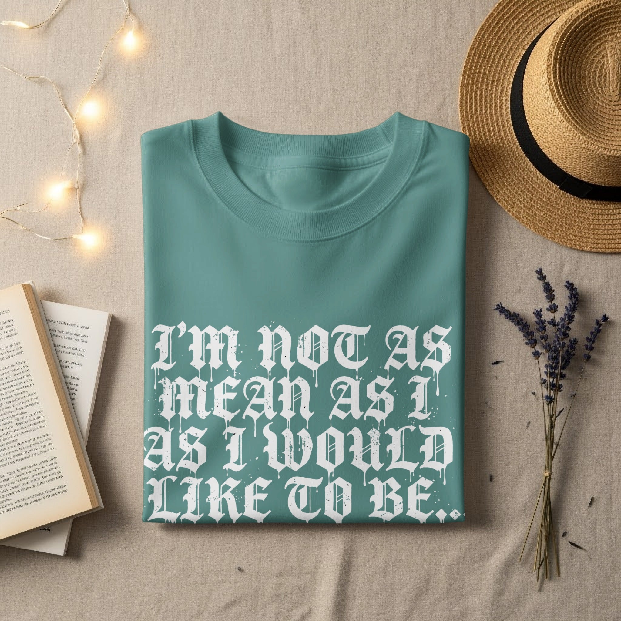 Teal t-shirt with "I'm not as mean as I would like to be" graphic.