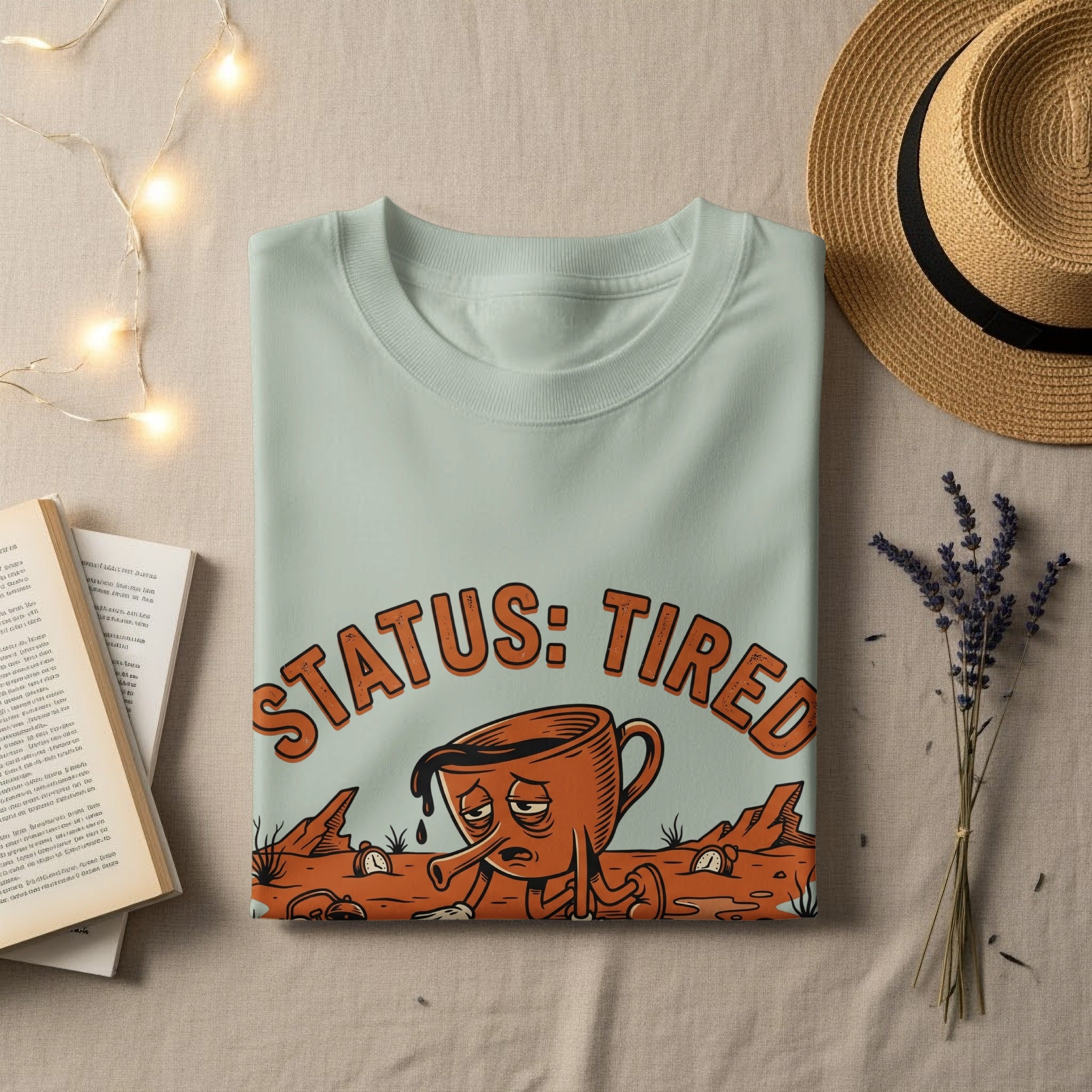 T-shirt with a cartoon coffee cup illustration and "STATUS: TIRED" text.