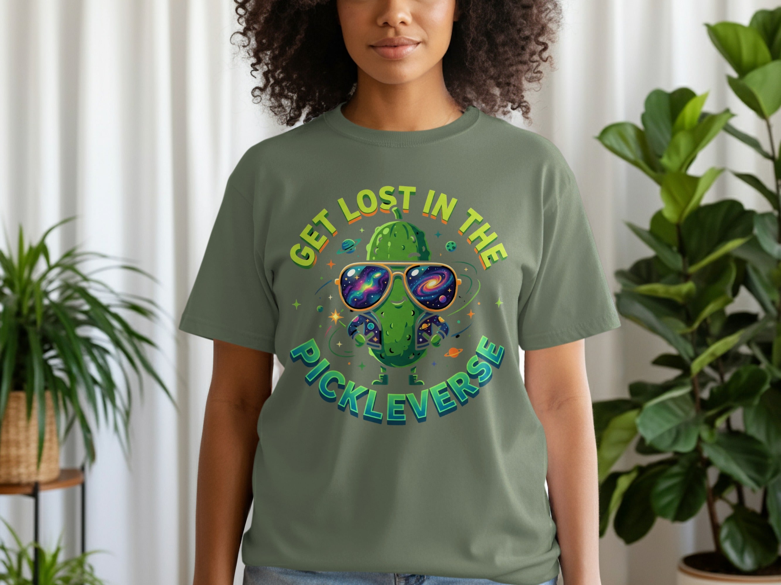 Green t-shirt with a smiling pickle wearing sunglasses and the text "GET LOST IN THE PICKLEVERSE."