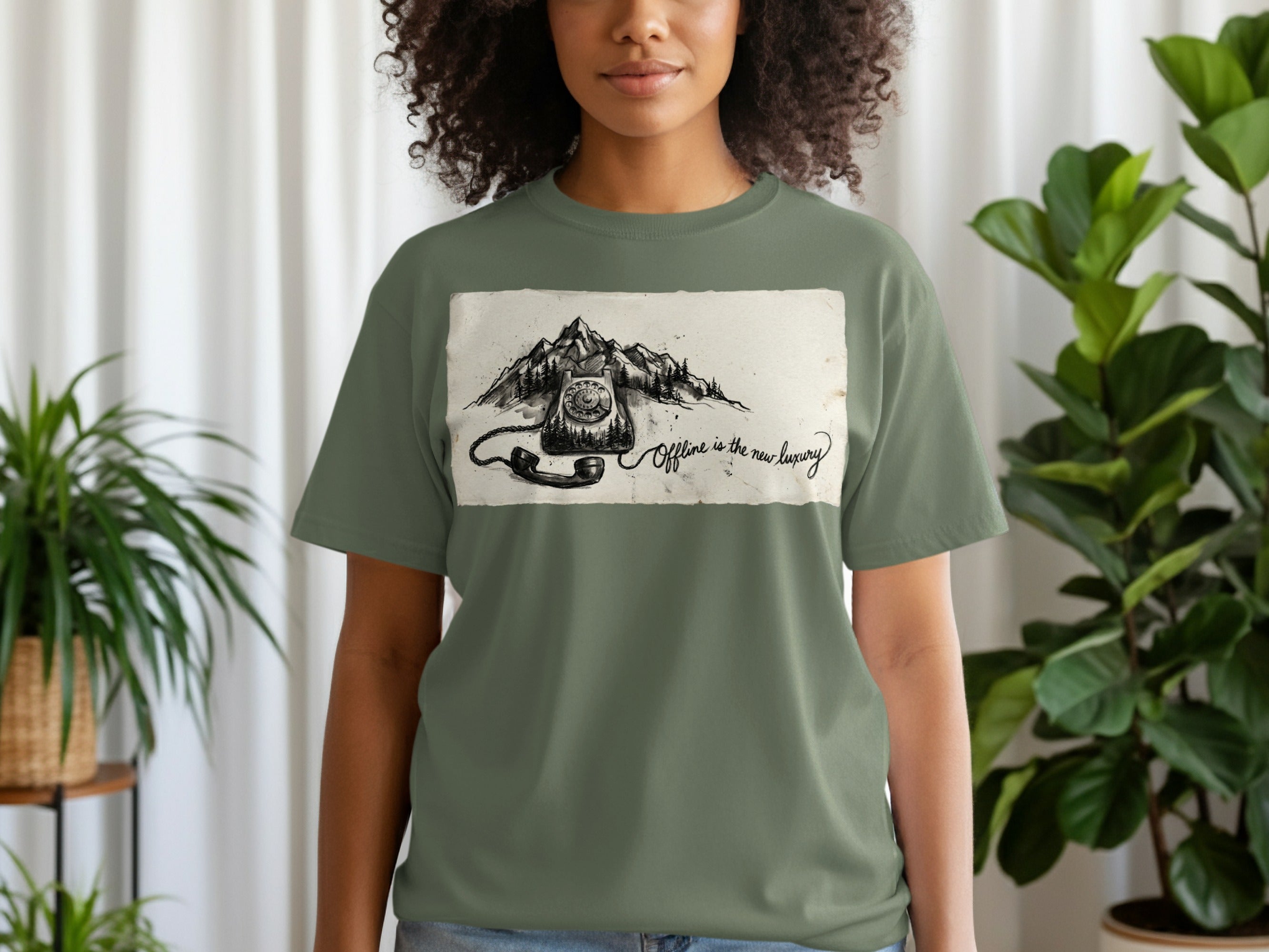 Olive green t-shirt with vintage phone graphic and "Offline is the new luxury" text.
