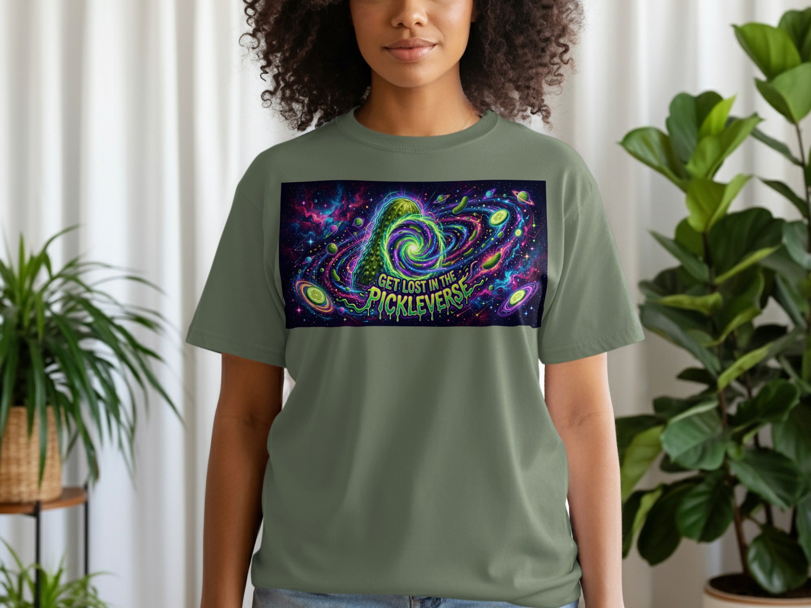 Green t-shirt with Rick and Morty Pickle Rick swirling in a cosmic galaxy.