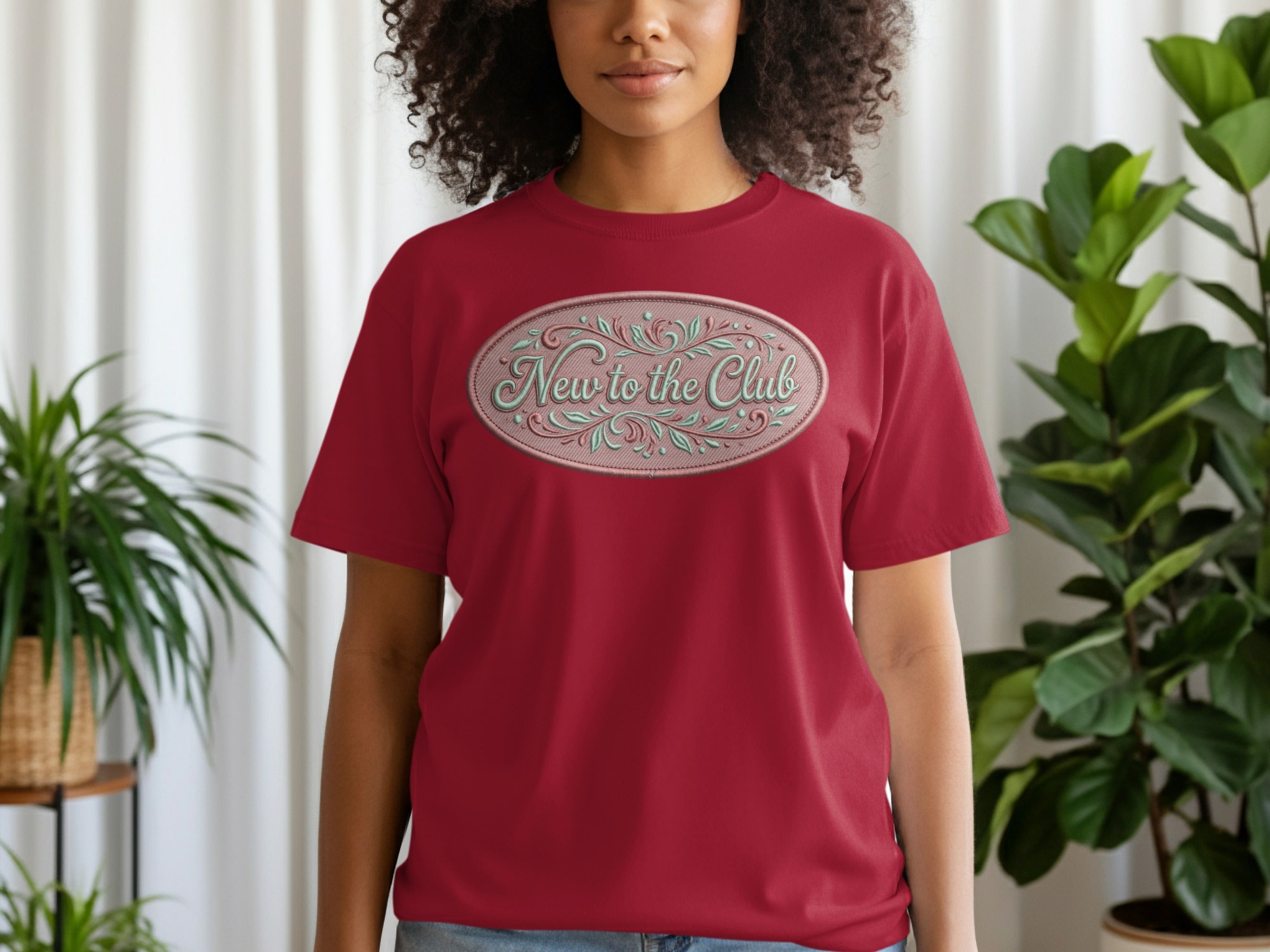 Red t-shirt with oval "New to the Club" text design.