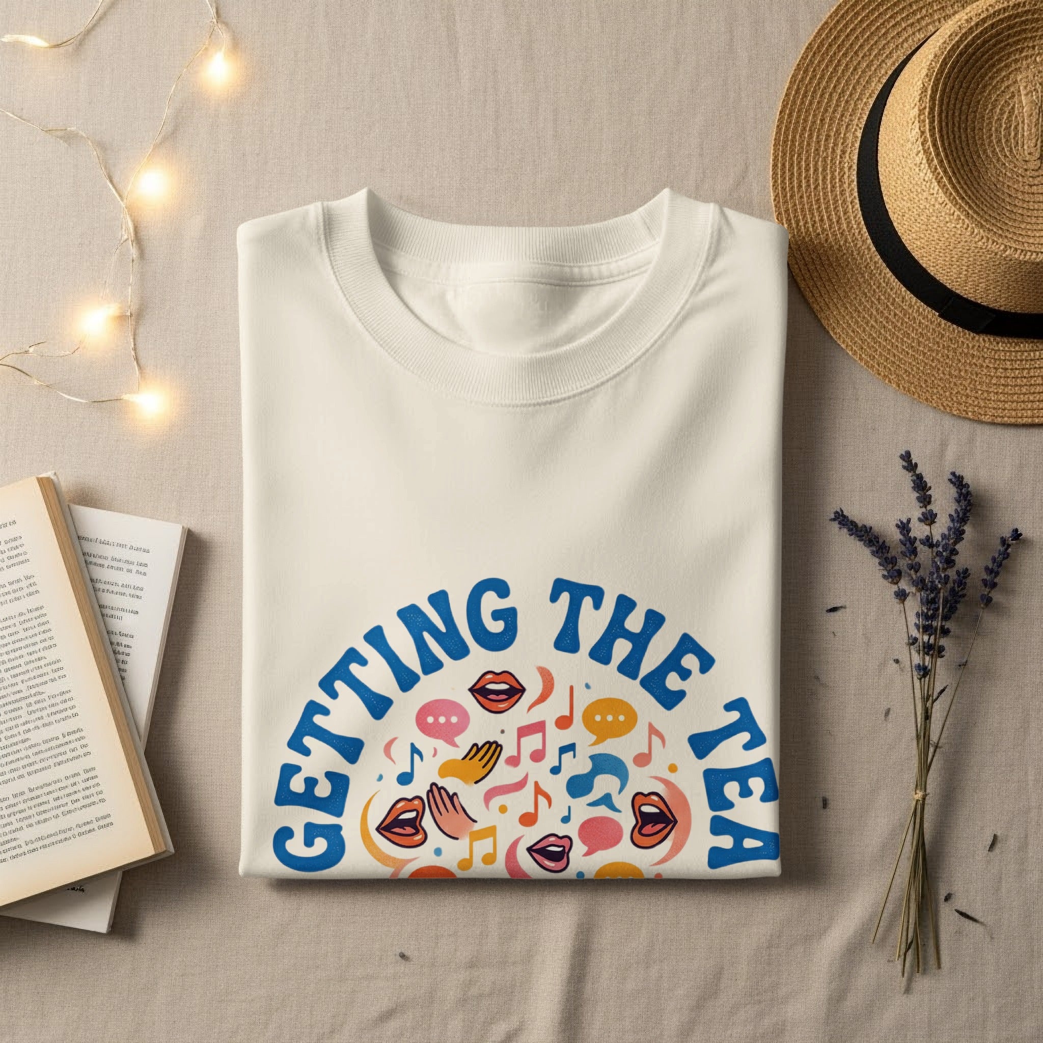 Cream t-shirt with "GETTING THE TEA" graphic of colorful mouths and musical notes.
