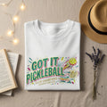 White t-shirt with "Got It Pickleball Club Champions" text and graphics.