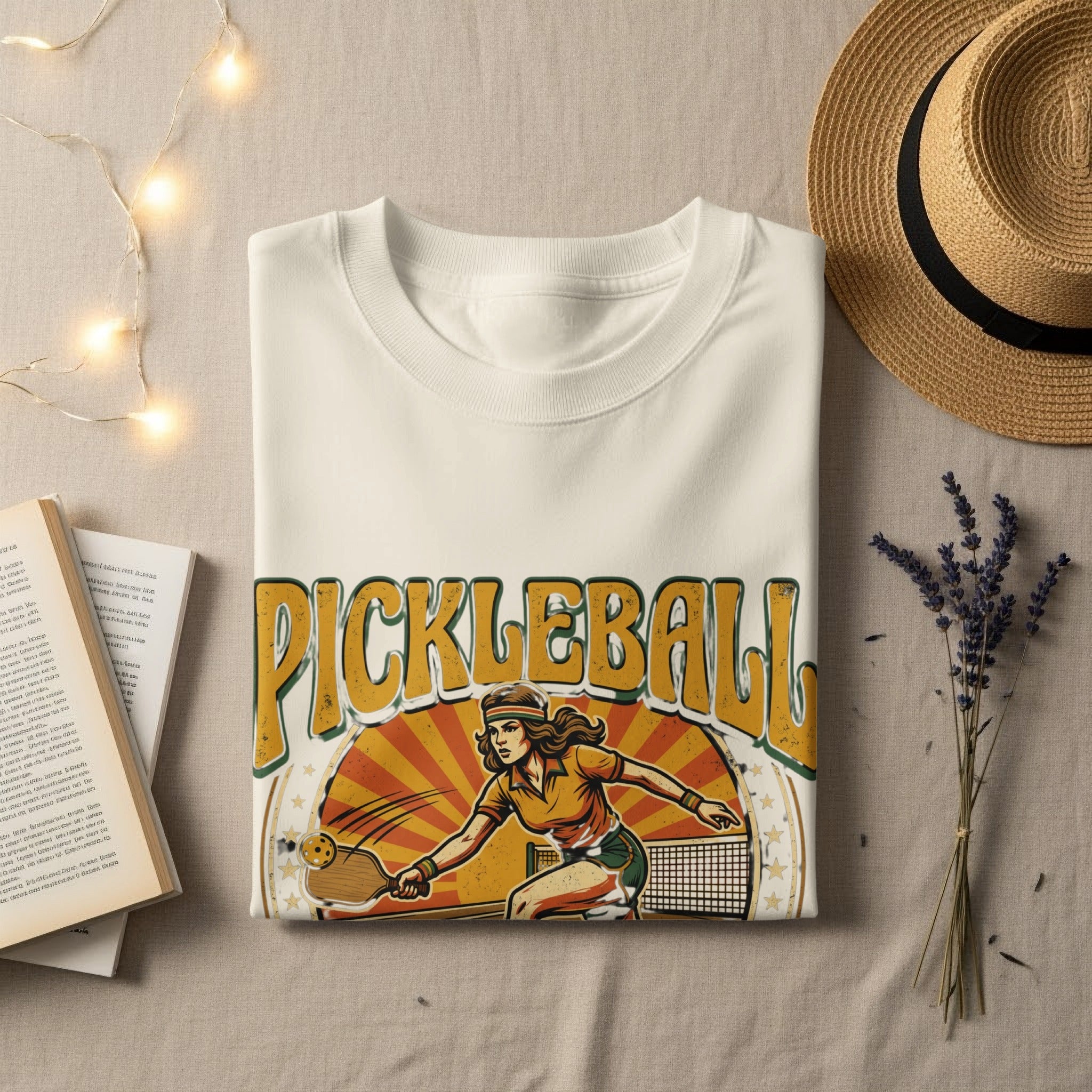 Cream t-shirt with distressed "Pickleball" graphic featuring a woman playing.