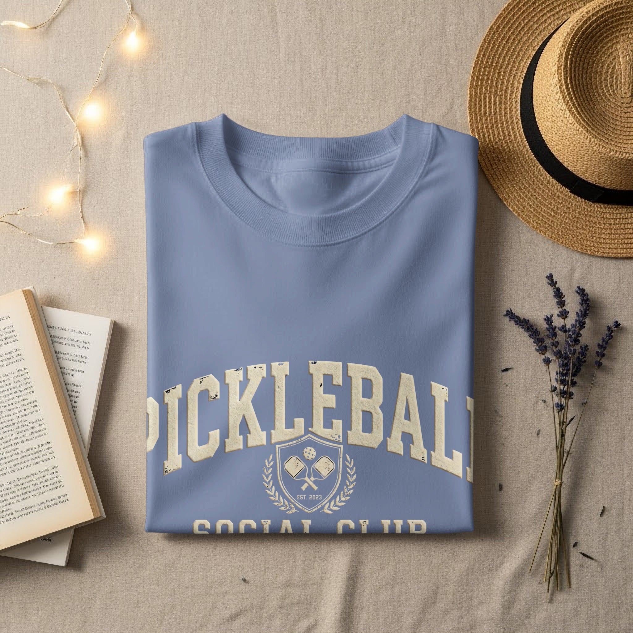Light blue t-shirt with "PICKLEBALL SOCIAL CLUB EST. 2023" text.