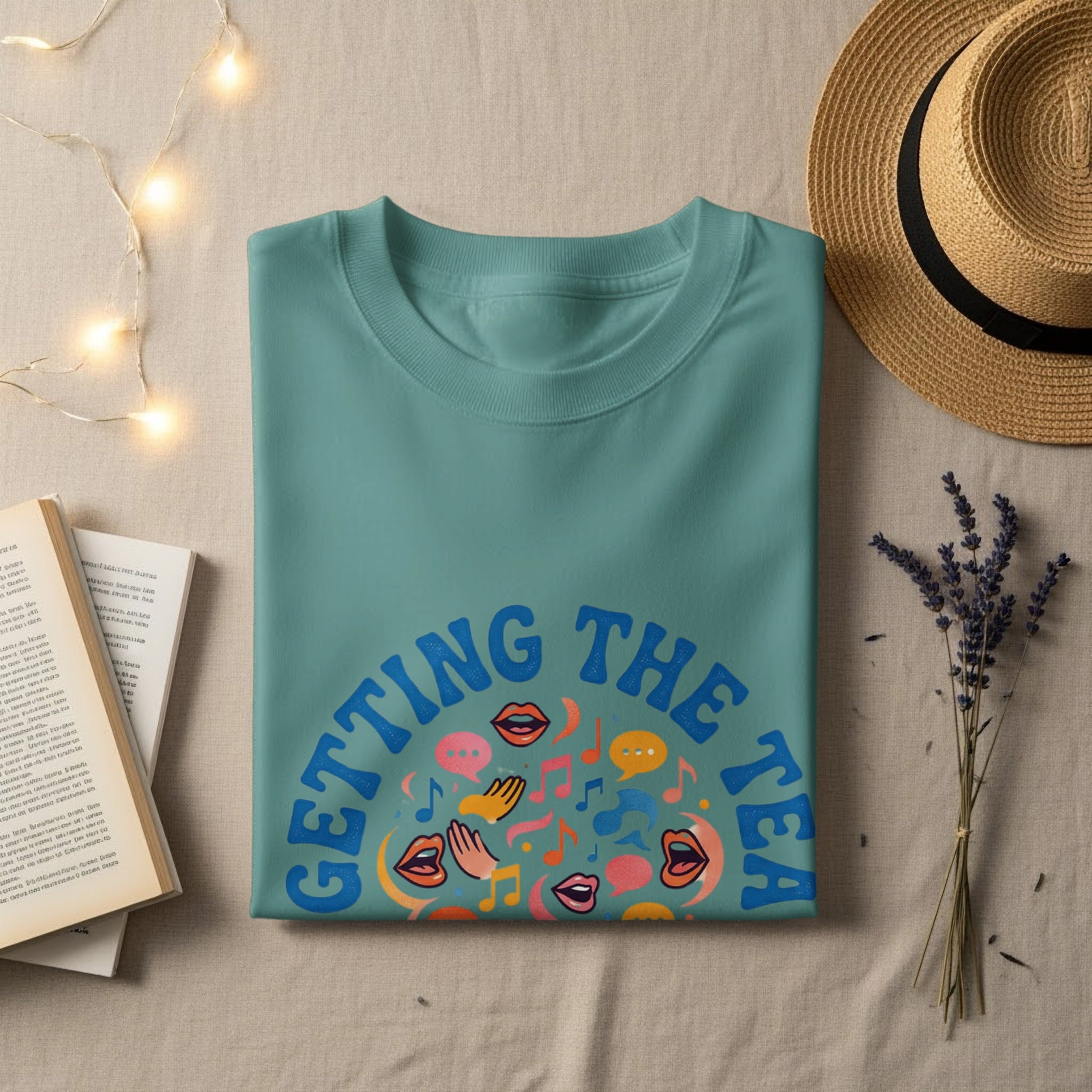 Teal t-shirt with "GETTING THE TEA" text and colorful speech bubble graphics.