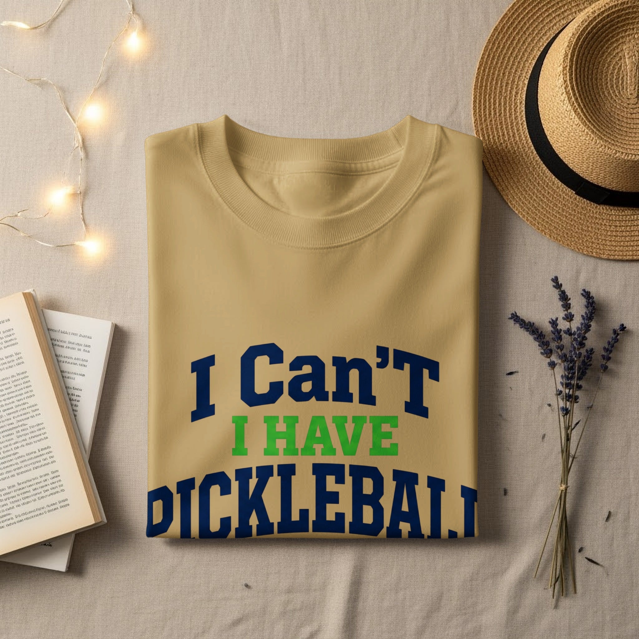 Tan t-shirt with "I Can't I HAVE PICKLEBALL" in blue and green text.