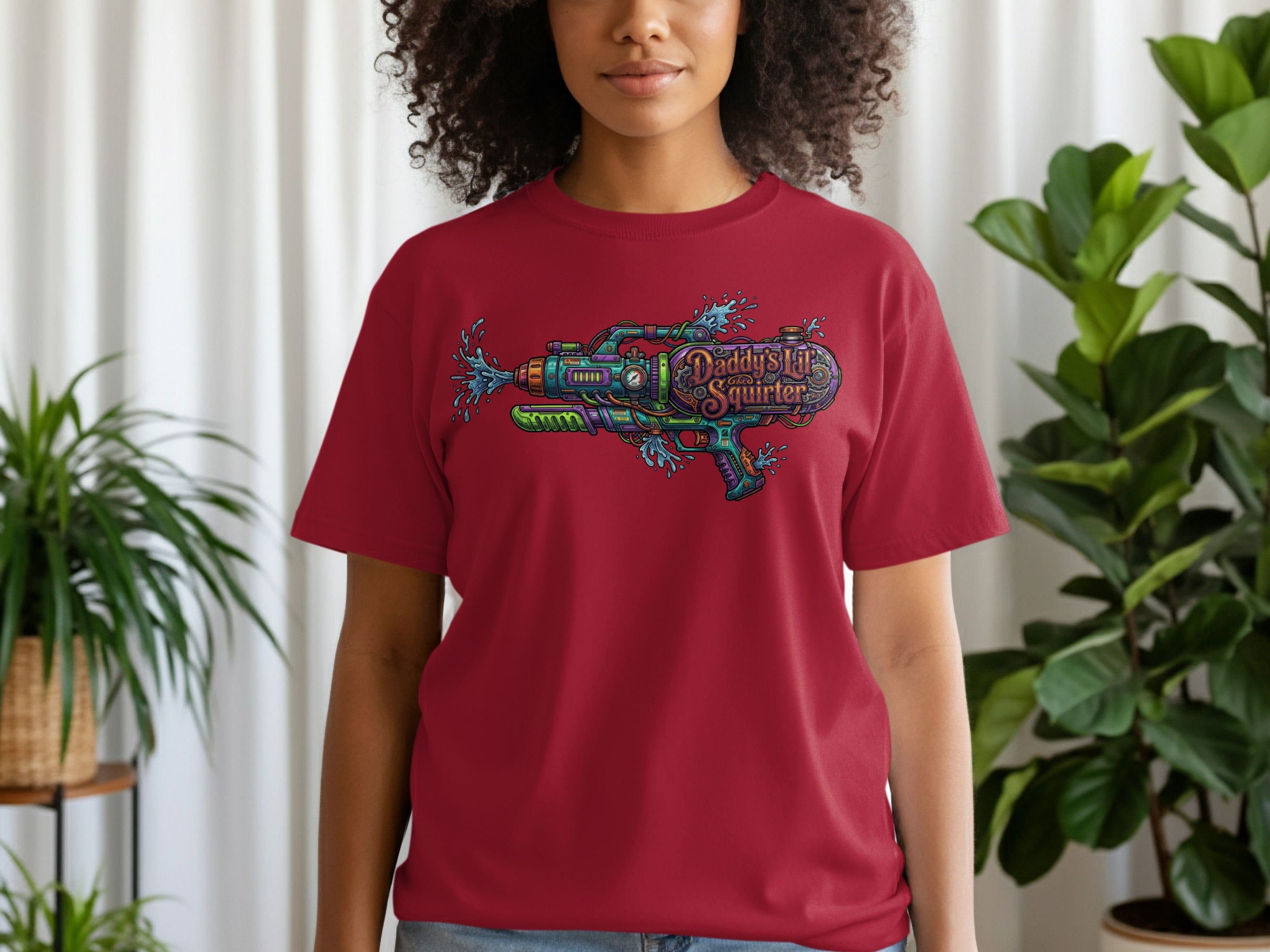 Red t-shirt with a colorful graphic of a water gun and the text "Daddy's Little Squirter".