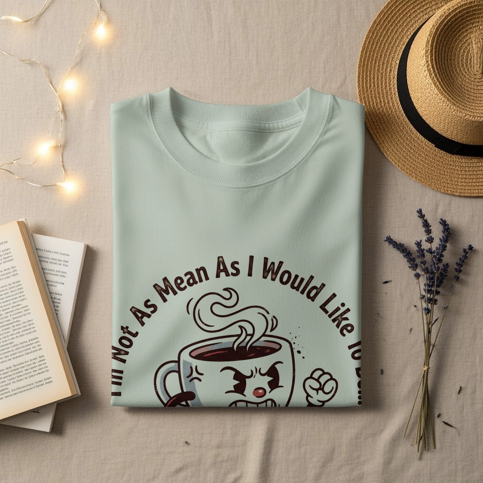 Light green t-shirt with "Not As Mean As I Would Like" text and cartoon coffee cup.