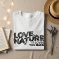 White t-shirt with "LOVE NATURE IT LOVES YOU BACK" text design.
