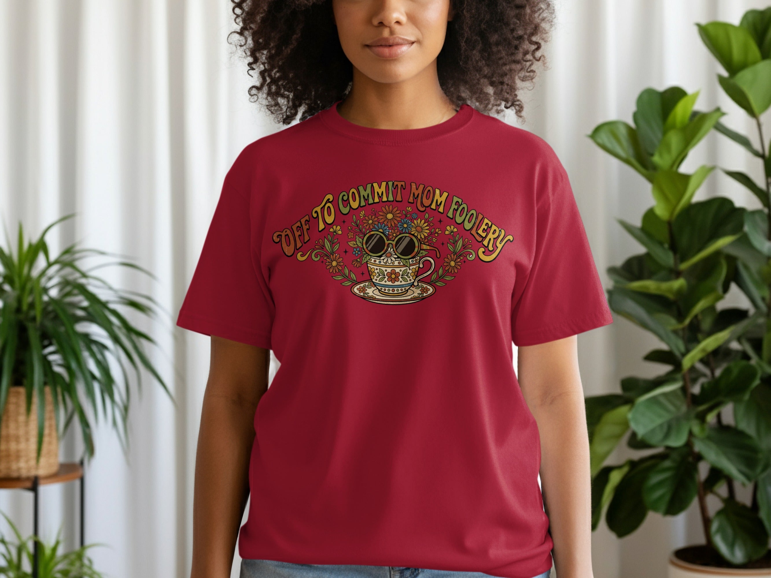 Red t-shirt with "Off to commit mom foolery" text and floral teacup design.