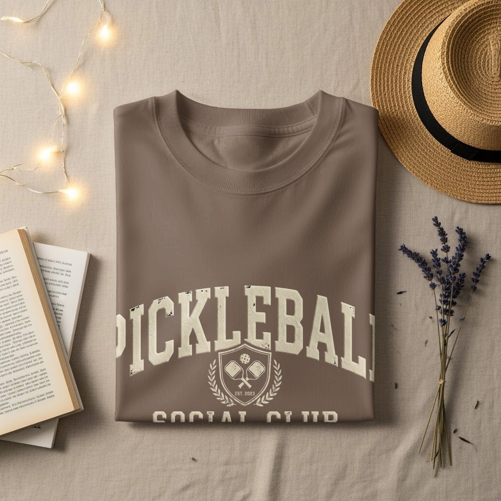 Brown t-shirt with "PICKLEBALL SOCIAL CLUB EST. 2023" text and logo.