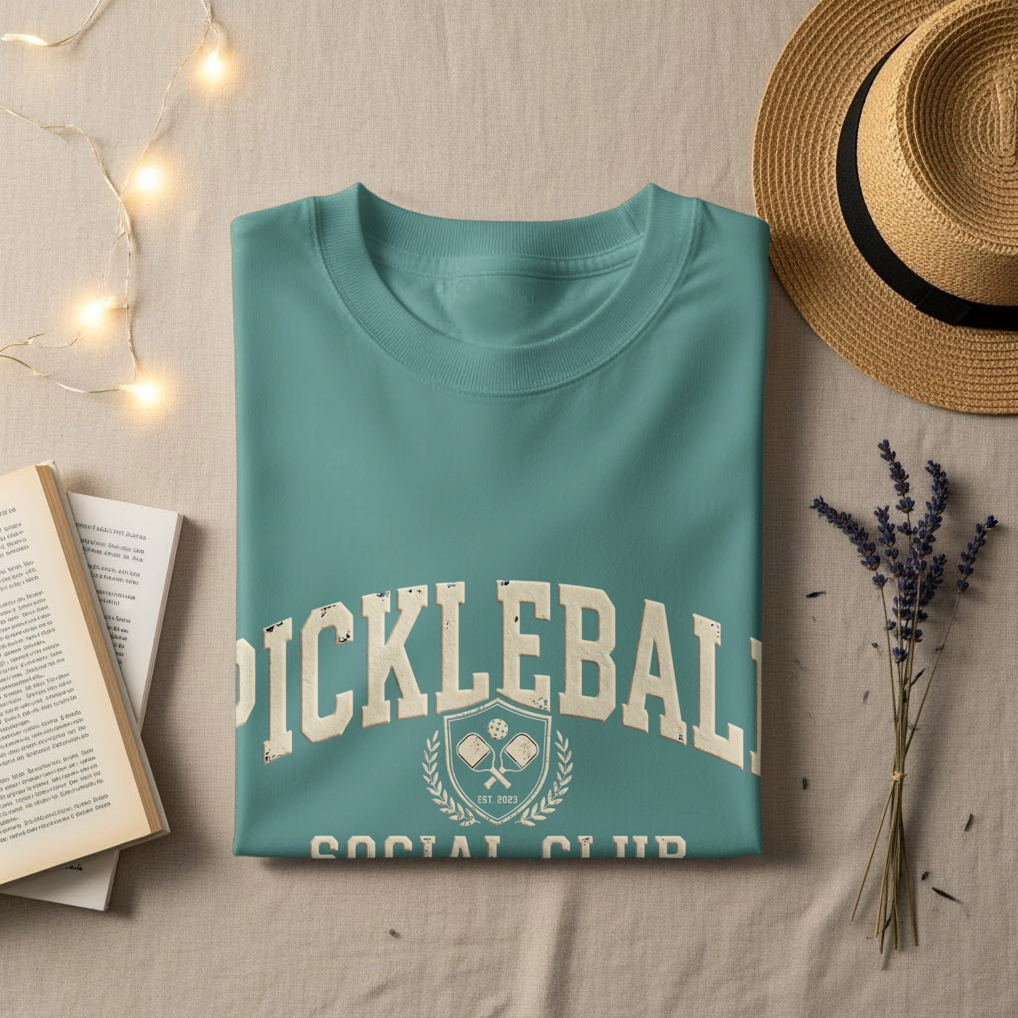 Teal "Pickleball Social Club Est. 2023" t-shirt with graphic overlay.