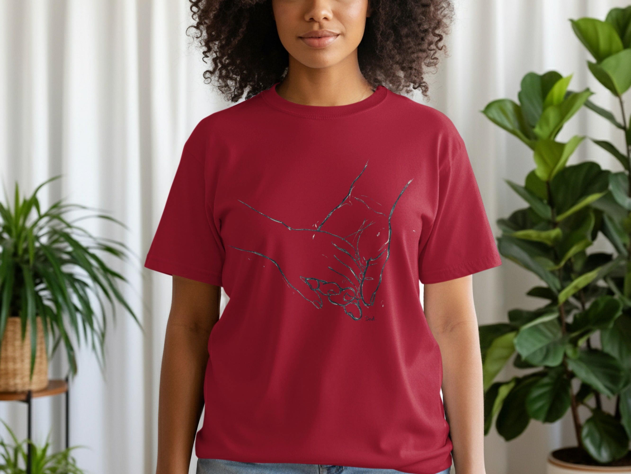 Red t-shirt with a line drawing of two hands clasped together.