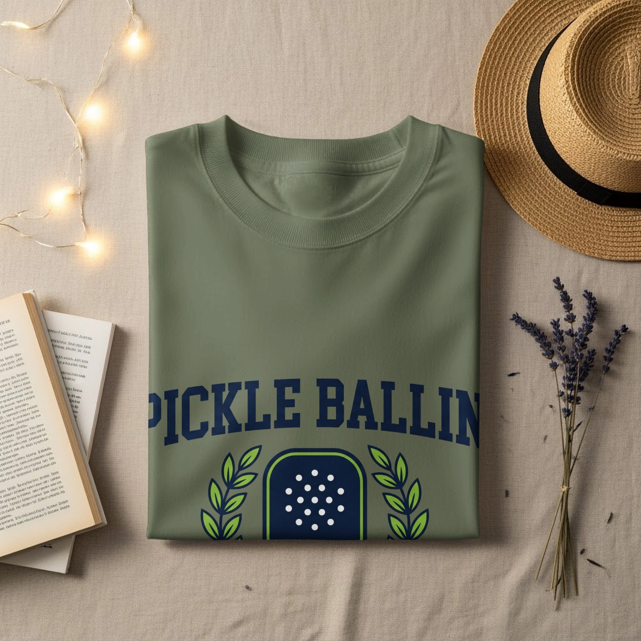 Olive green t-shirt with "PICKLE BALLIN'" graphic and distressed white dots.