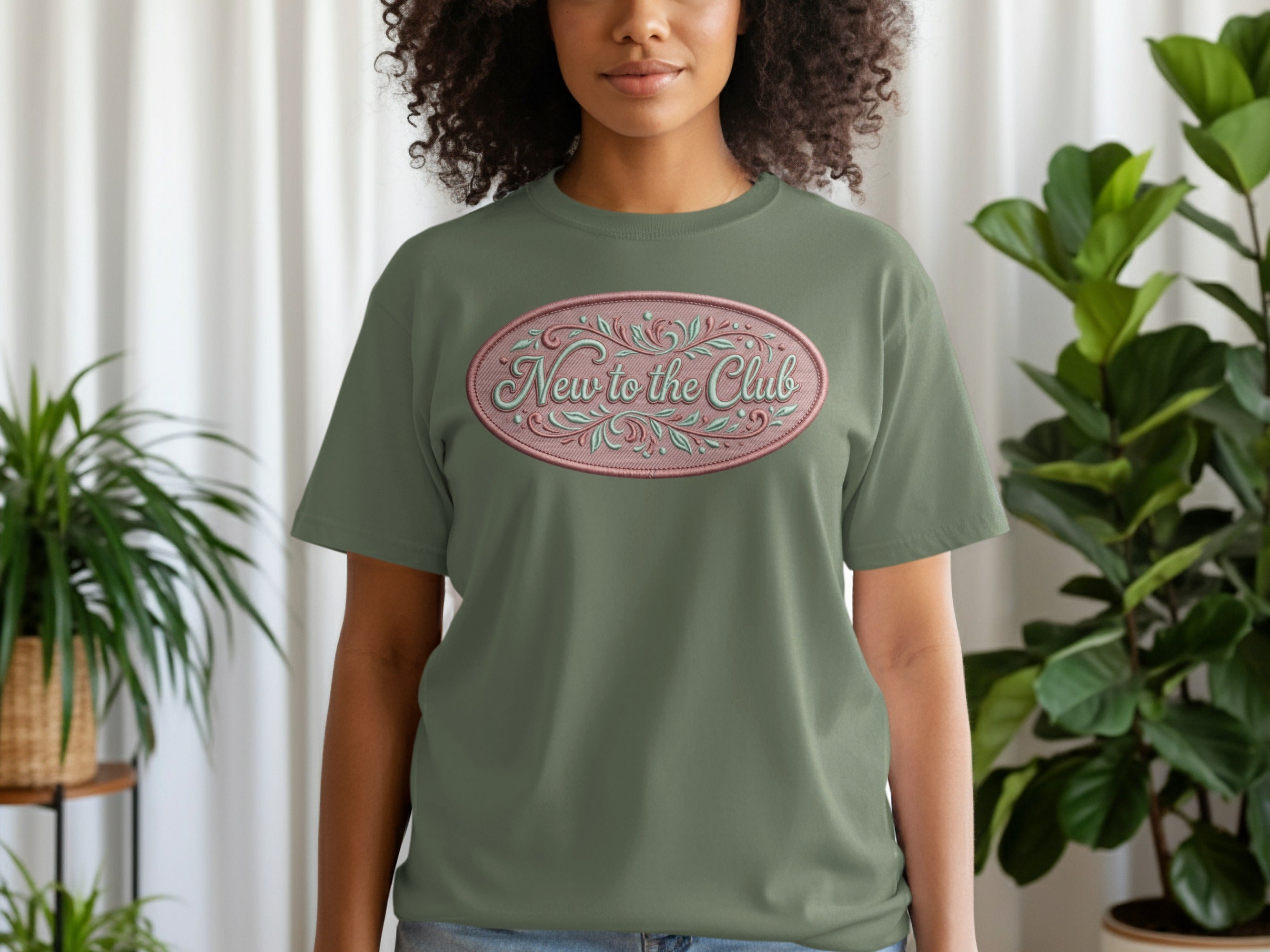 Olive green t-shirt with oval "New to the Club" embroidered text.