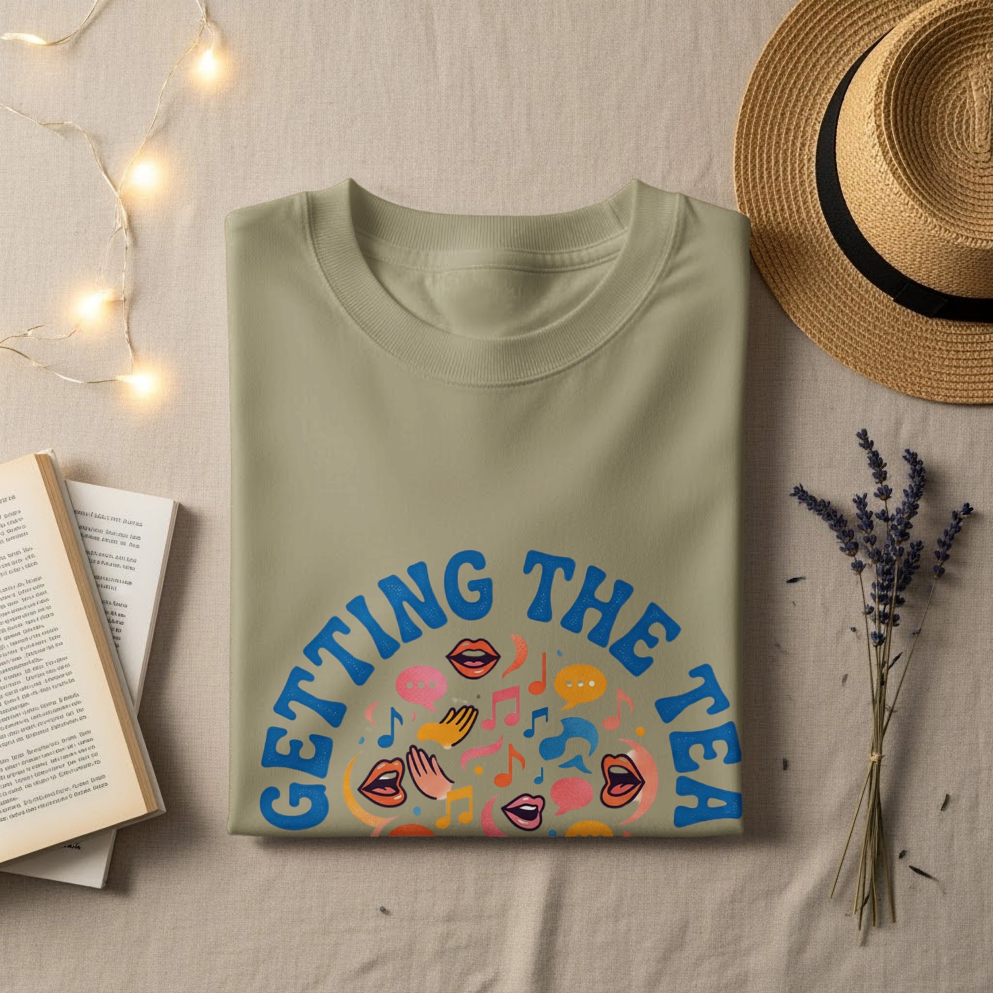 Light green t-shirt with "GETTING THE TEA" and colorful graphic design.