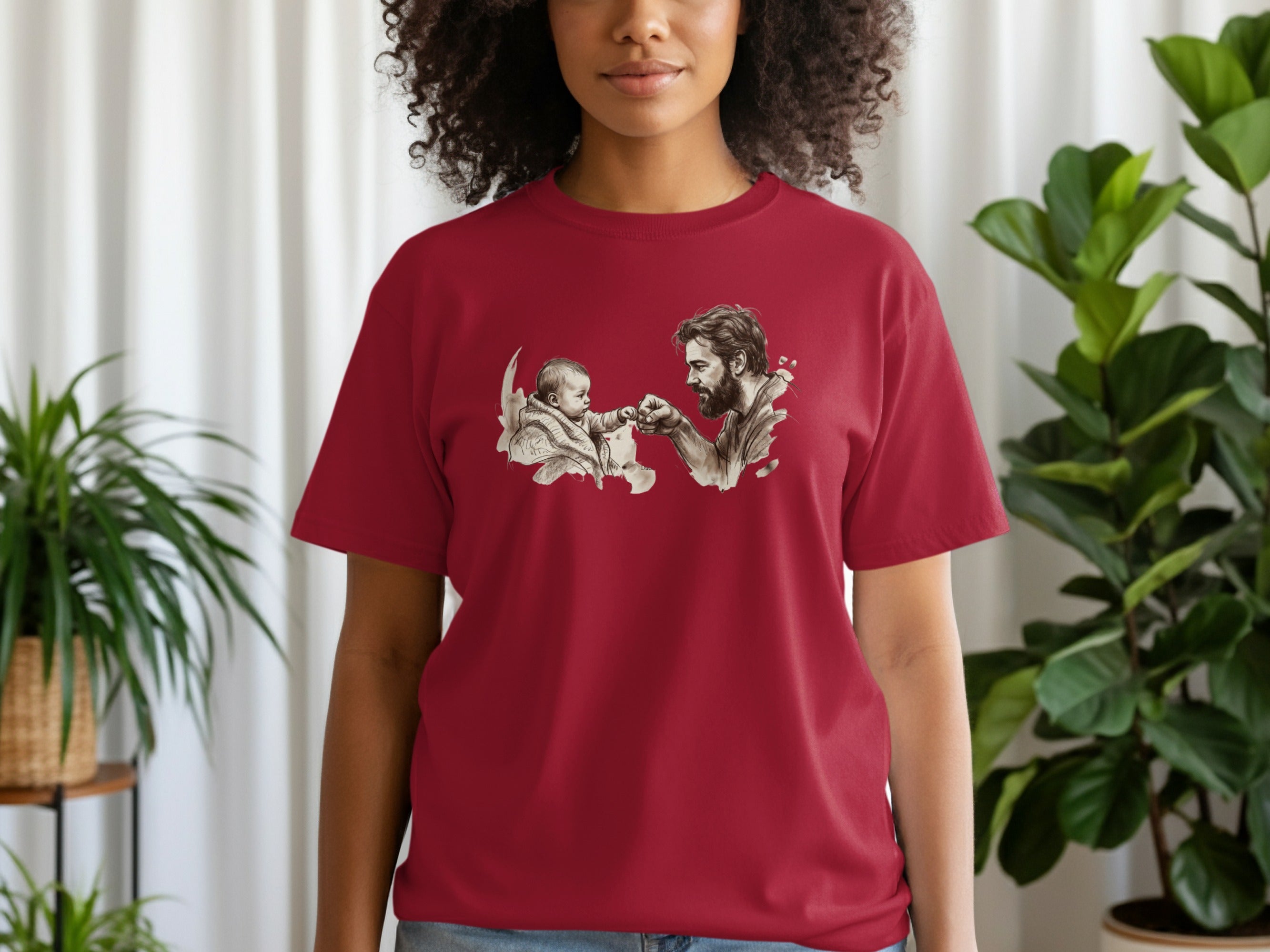 Father and child high-five on maroon t-shirt.