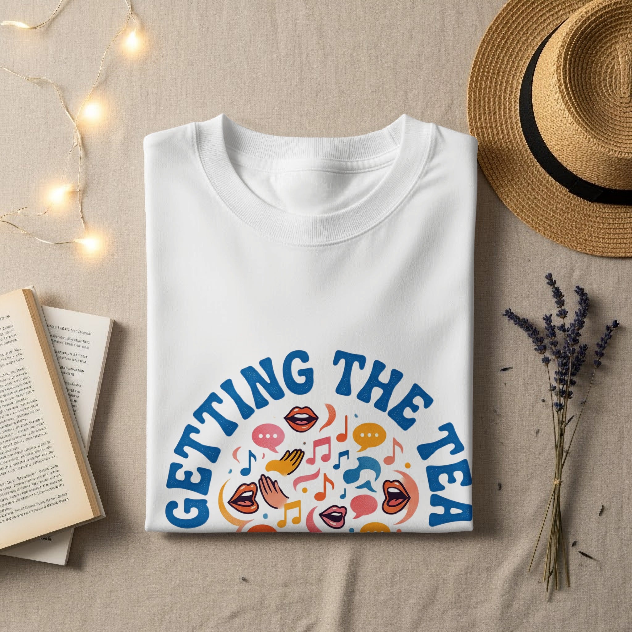 White t-shirt with "Getting the Tea" text and colorful graphic icons.