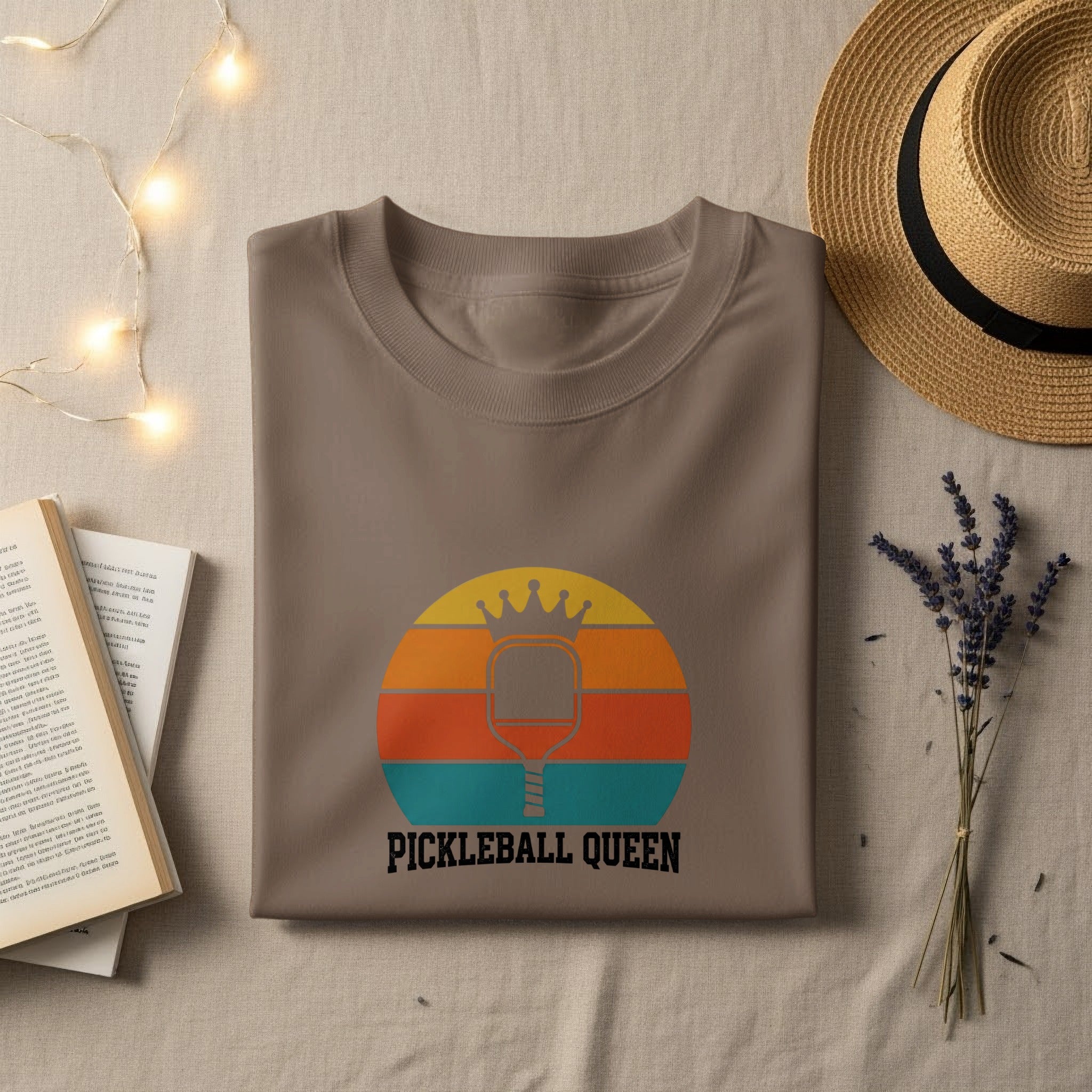 Brown t-shirt with "PICKLEBALL QUEEN" and retro pickleball paddle graphic.