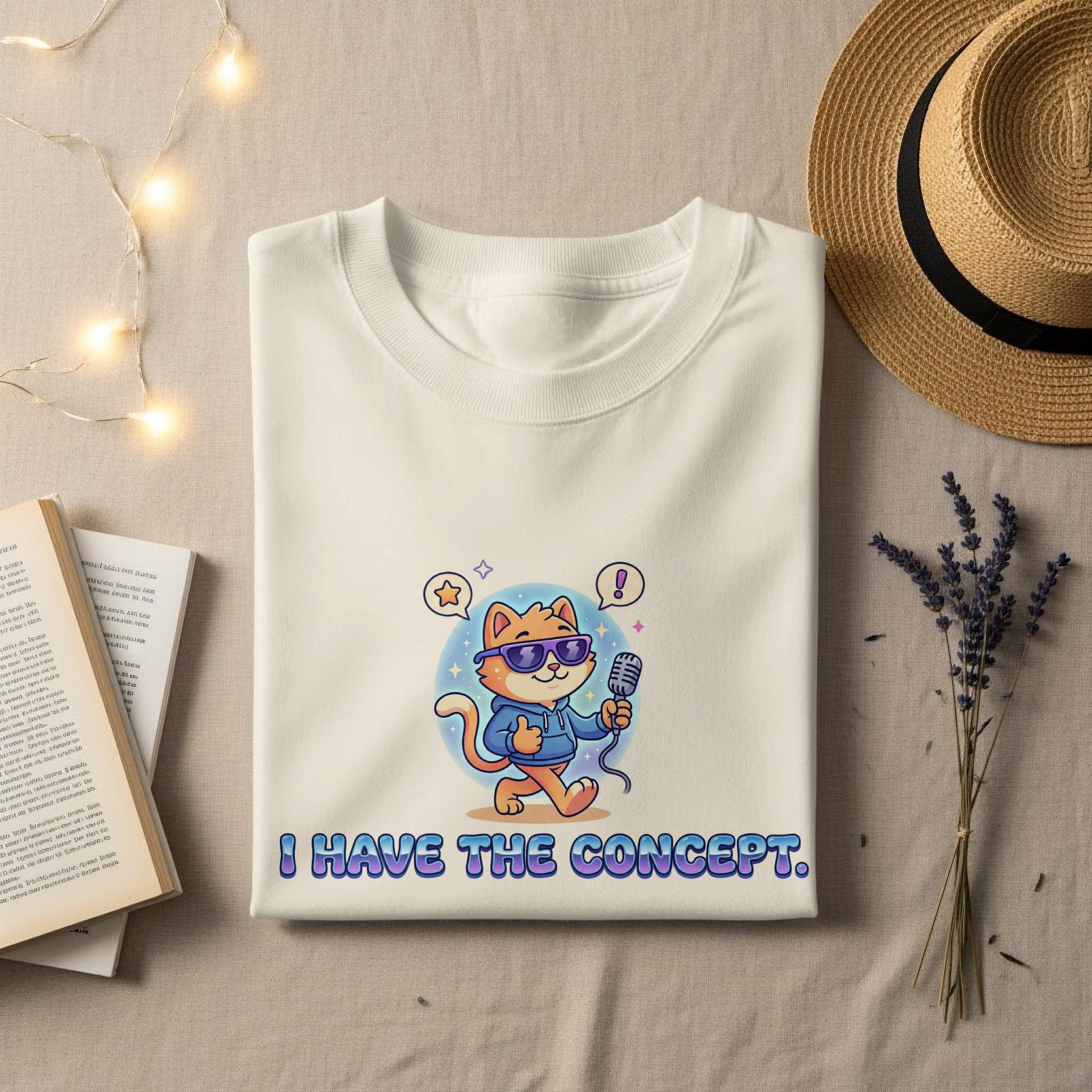 Cream t-shirt with a cartoon cat holding a microphone, saying "I HAVE THE CONCEPT."
