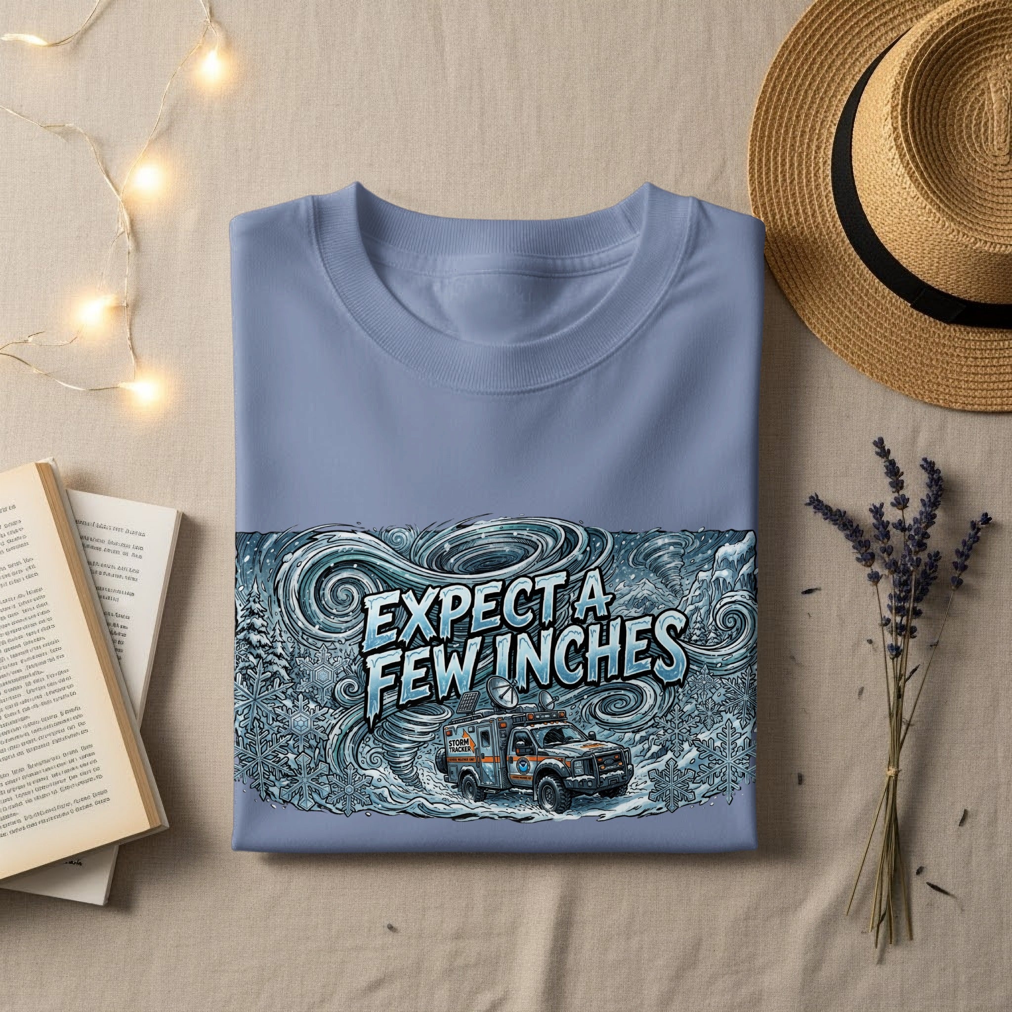 Blue t-shirt with "Expect A Few Inches" and storm illustration.
