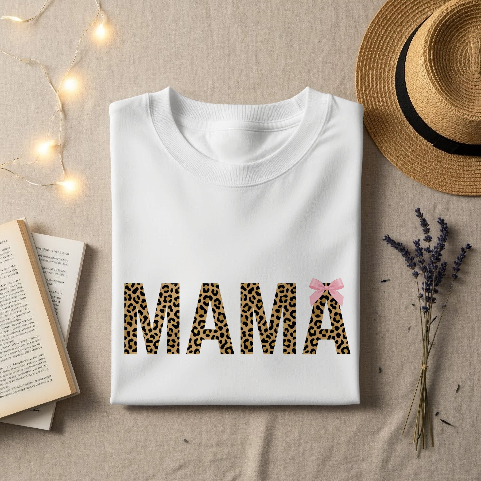 White t-shirt with "MAMA" in leopard print and a pink bow.