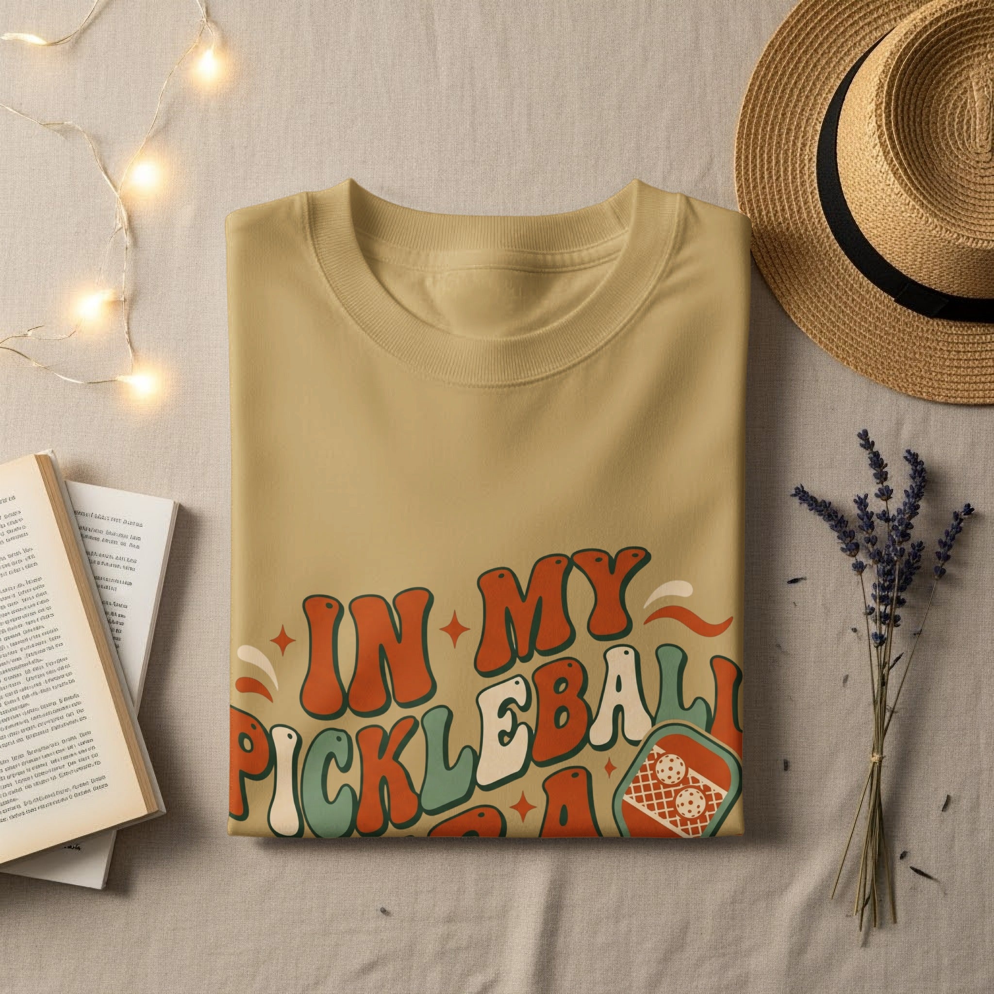Tan t-shirt with "IN MY PICKLEBALL ERA" text and pickleball graphic.