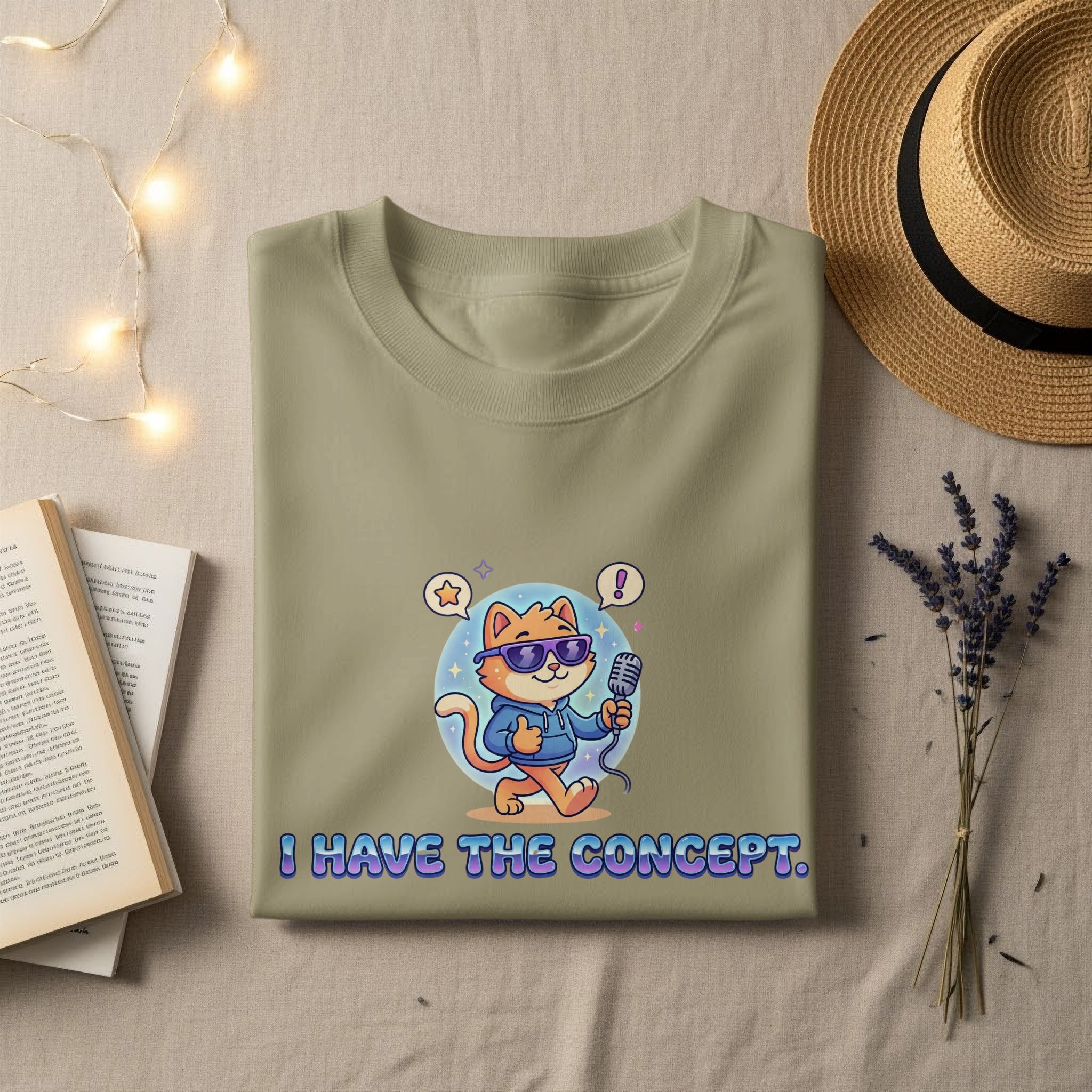 Olive green t-shirt with cartoon cat holding microphone and text "I HAVE THE CONCEPT."