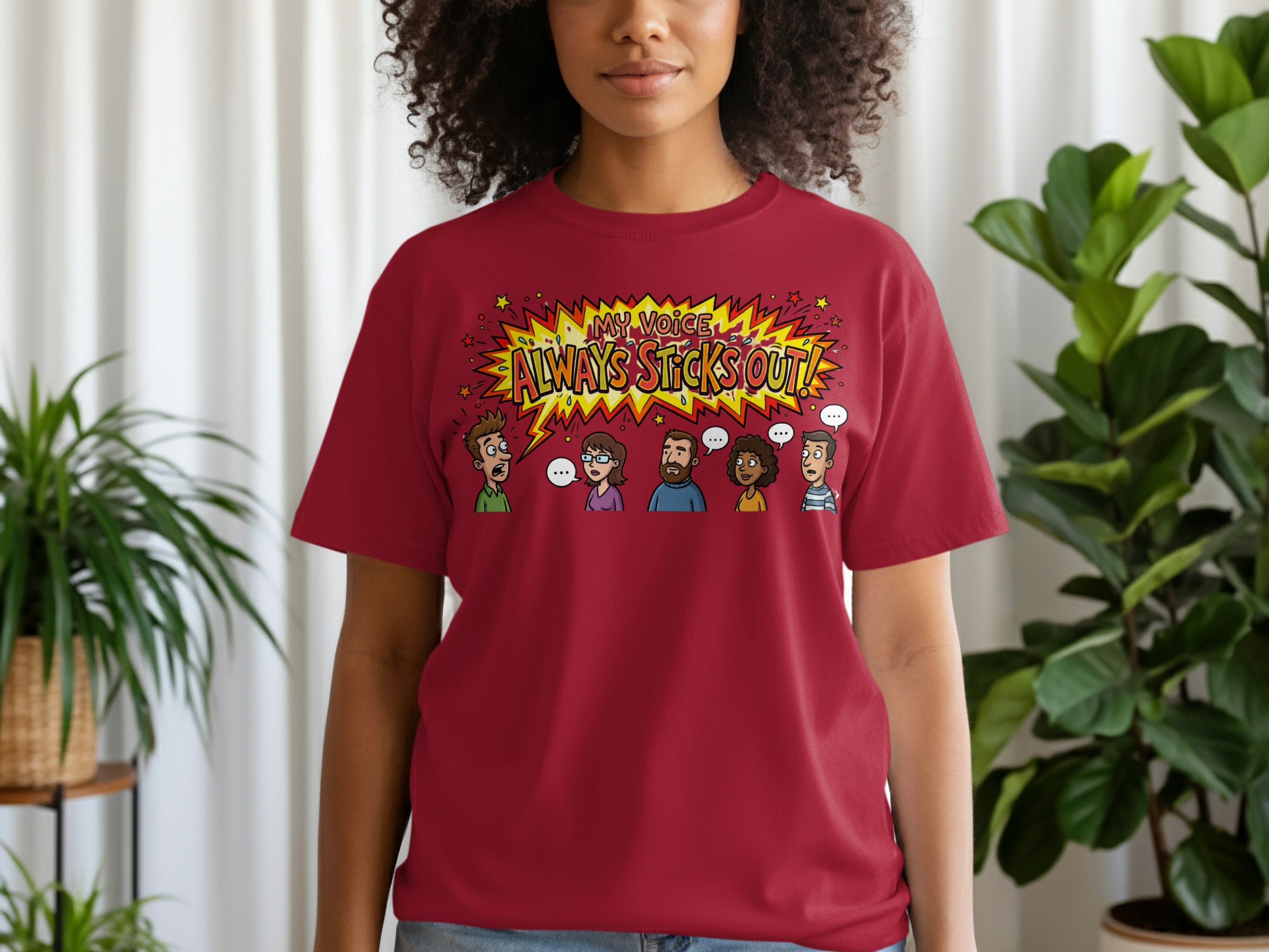 Maroon t-shirt with yellow burst graphic and text: "MY VOICE ALWAYS STICKS OUT!"